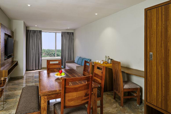 Suite living area with dining table and forest view