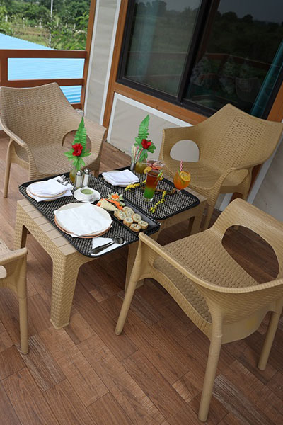 Balcony breakfast setup with fresh juice and snacks