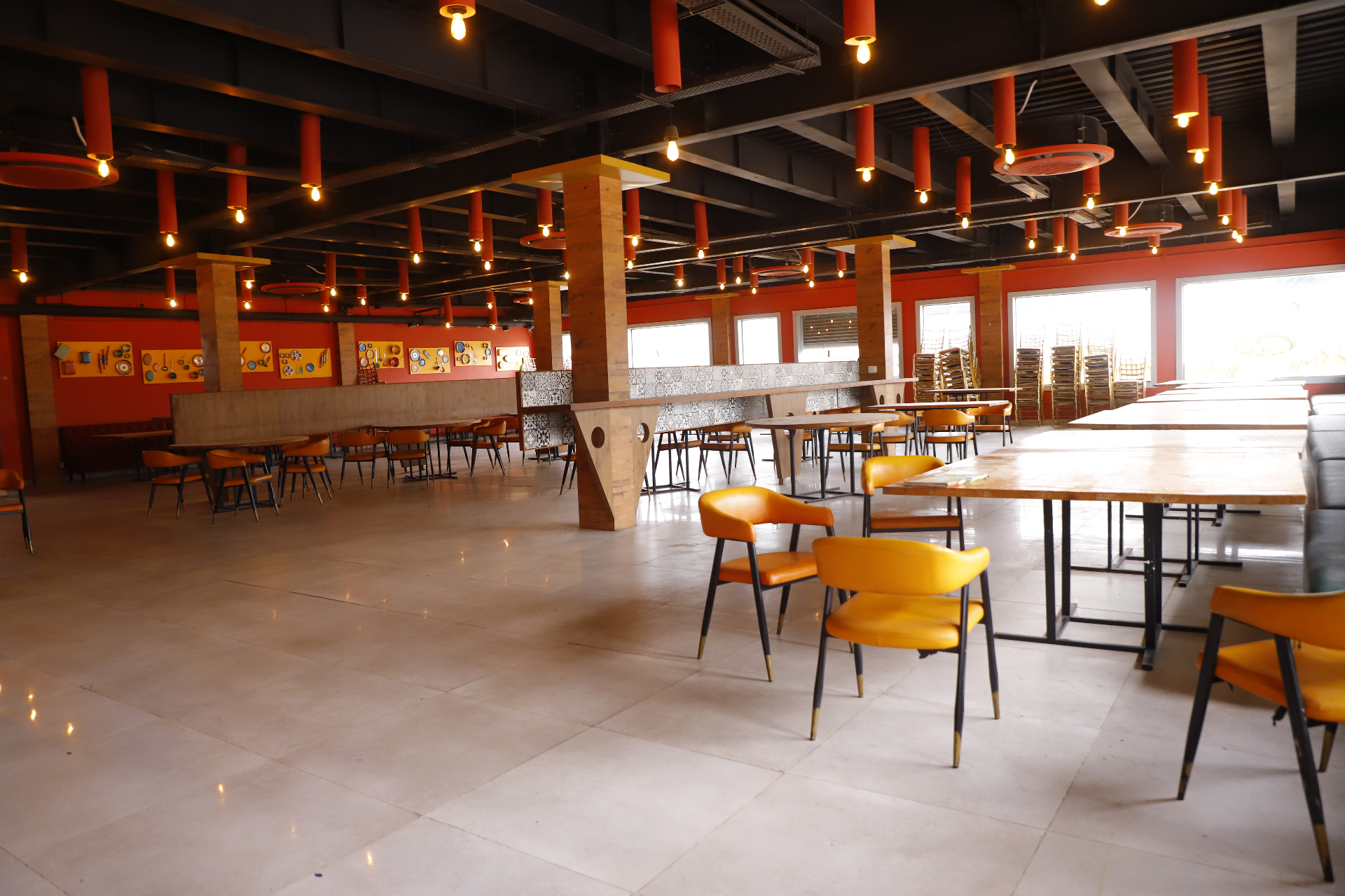 Warmly lit multi-cuisine restaurant with orange accents