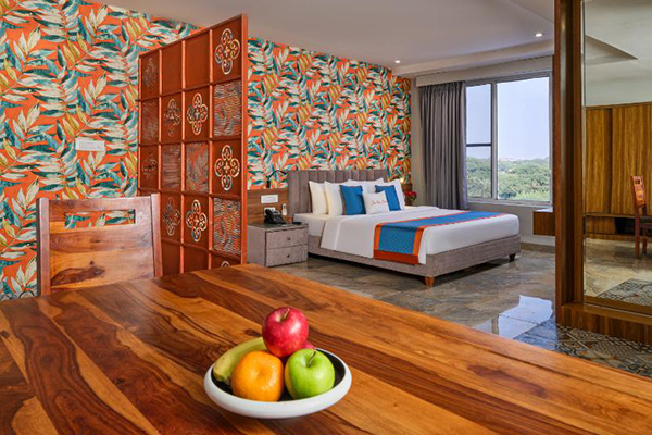 Luxury suite with tropical mural and king bed