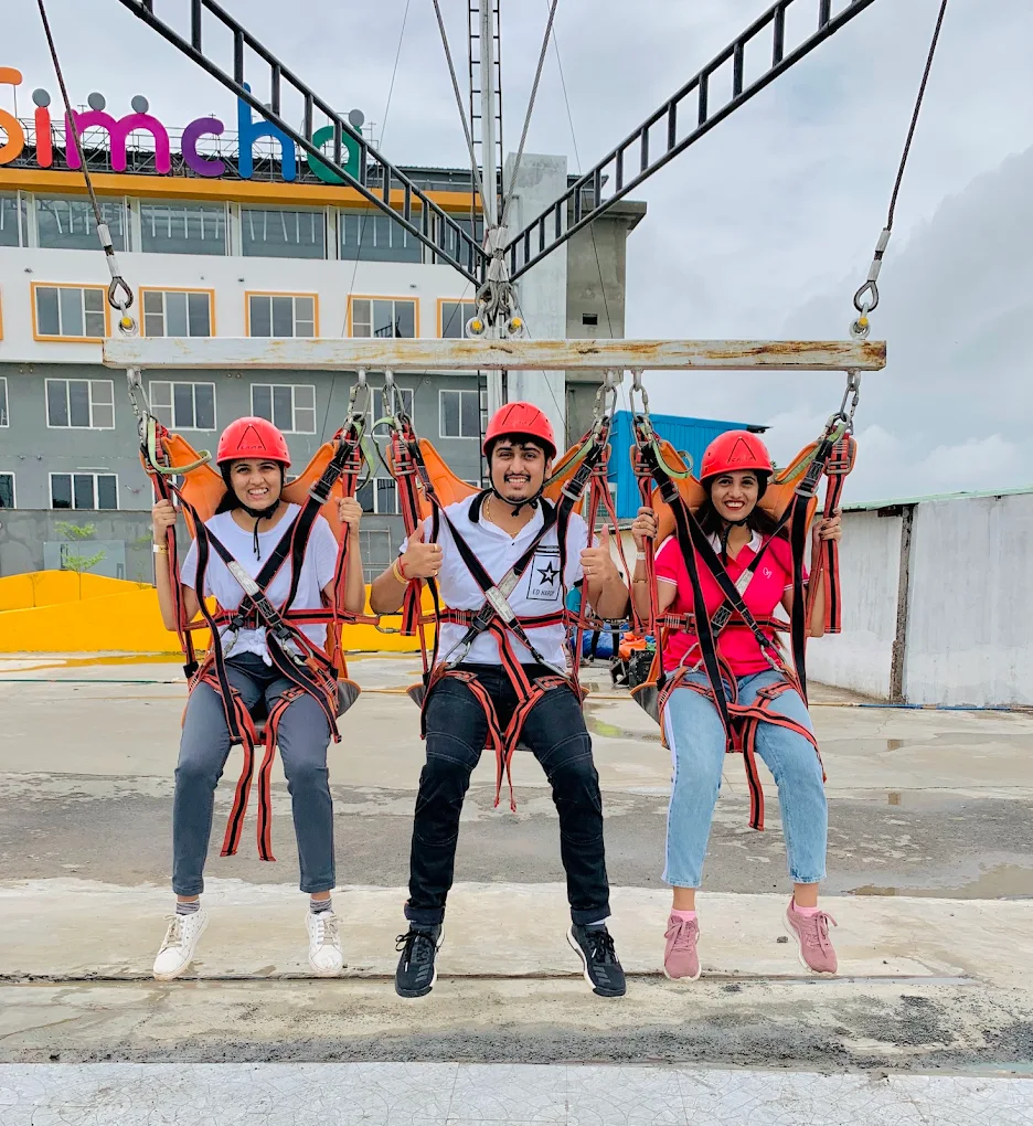 Friends strapped into the swing ride at Simcha